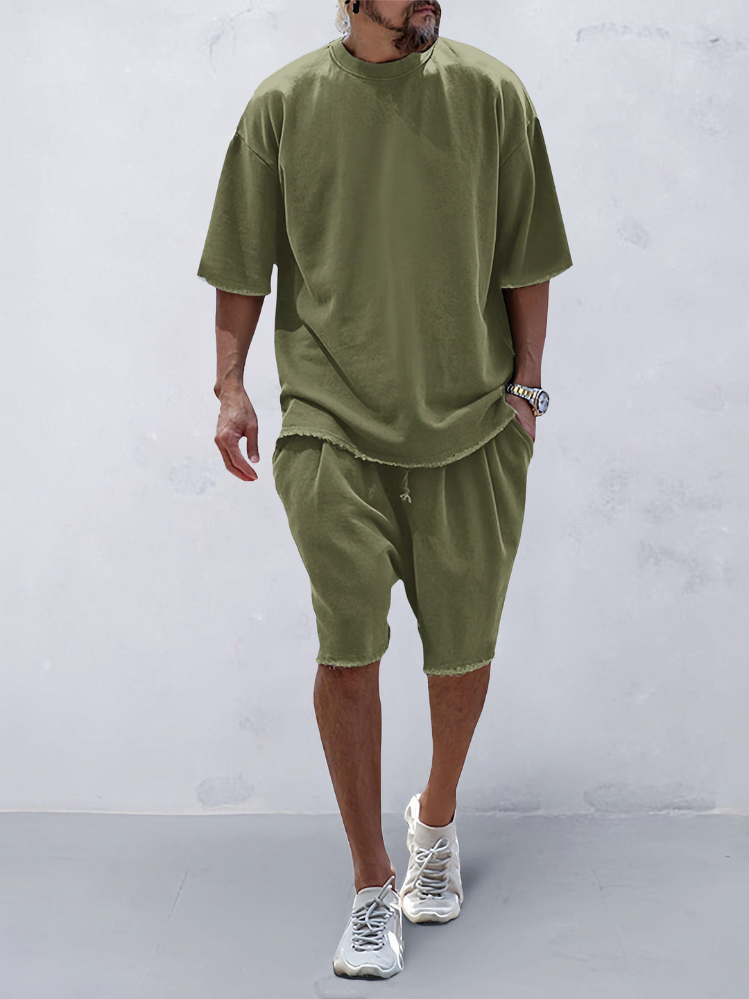 Man enjoying comfort in a solid color two-piece activewear set for daily wear.