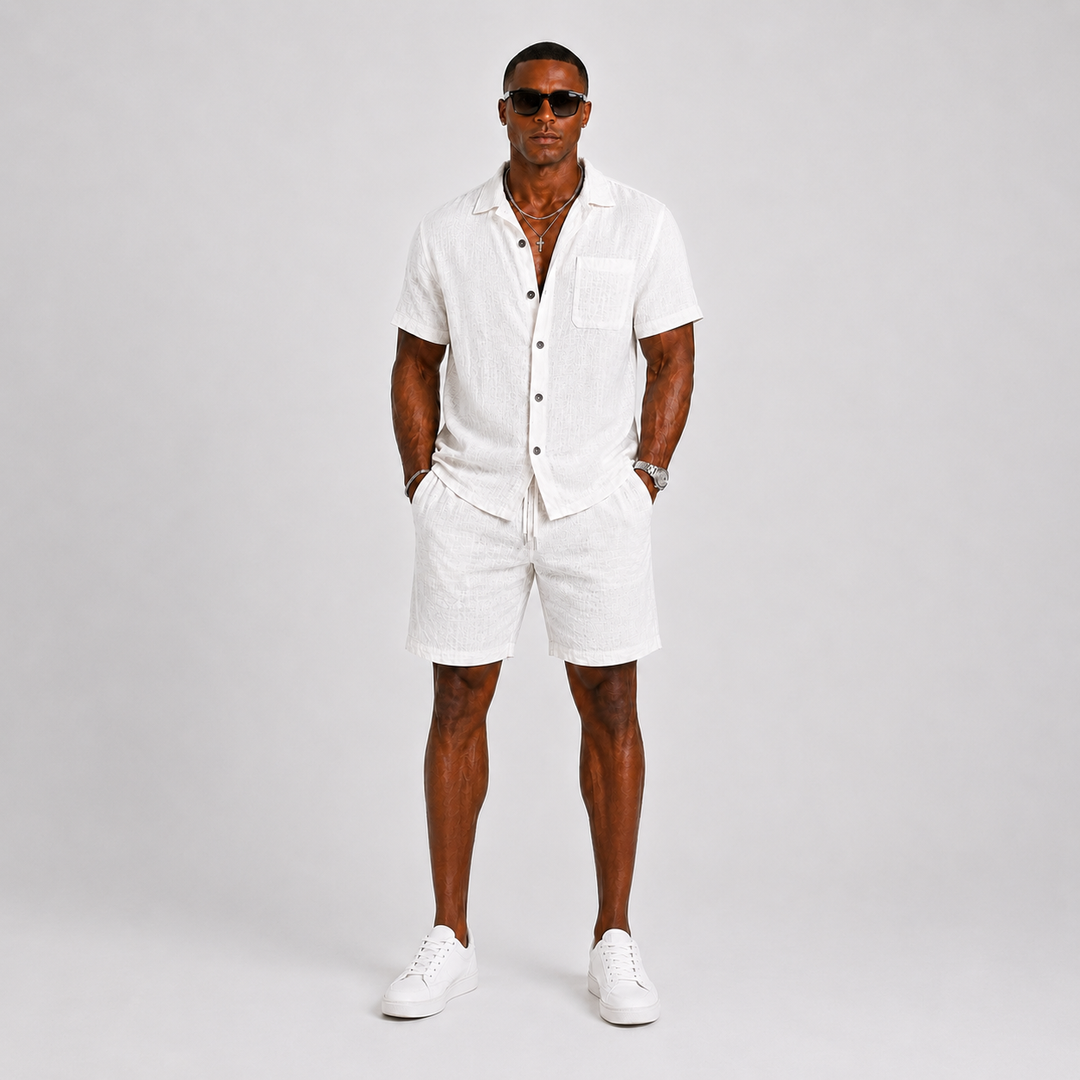 Stylish men's summer two-piece set featuring a short-sleeve relaxed fit shirt & matching shorts with an elastic waist.