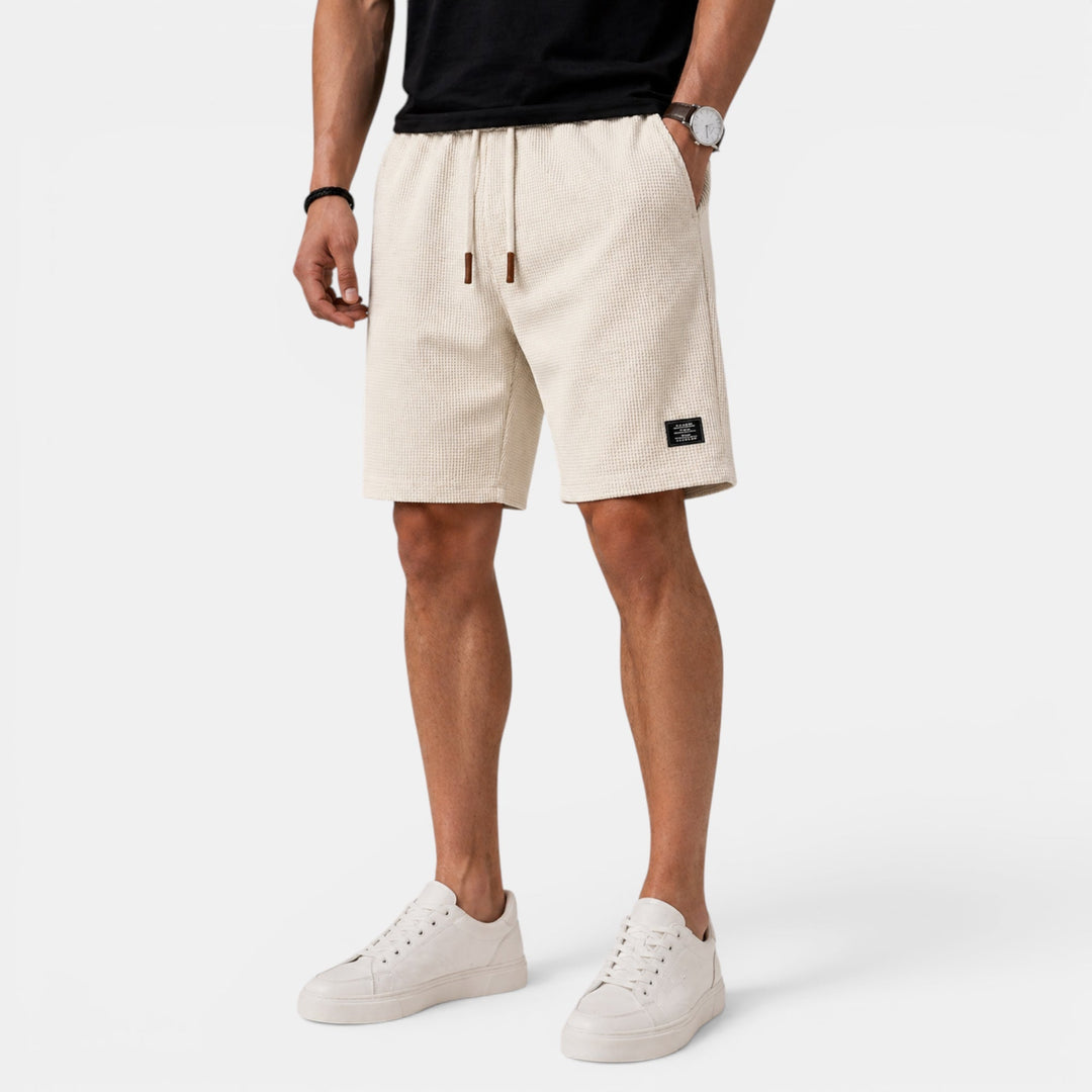 Men's relaxed fit summer shorts with elastic waist, drawstring, & pockets. Perfect for casual wear & beach.