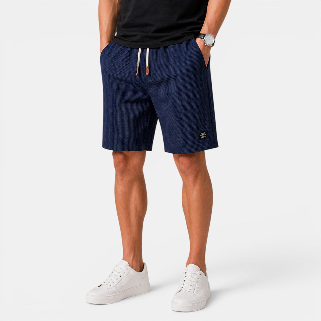 Close-up: Men's relaxed fit summer shorts with elastic waist, drawstring. Comfortable & stylish casual fashion.