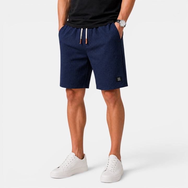 Close-up: Men's relaxed fit summer shorts with elastic waist, drawstring. Comfortable & stylish casual fashion.