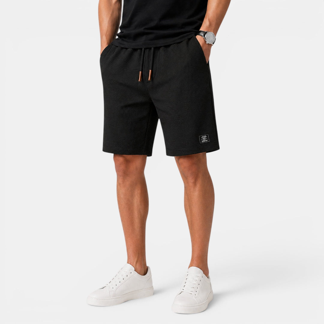 Back view of men's relaxed fit summer shorts showing practical pockets. Elastic waist for all-day comfort.
