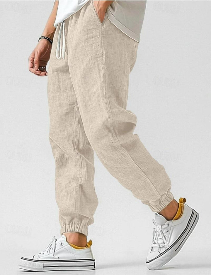 Man wearing relaxed fit summer trousers, showcasing effortless style for warm weather activities and casual wear.
