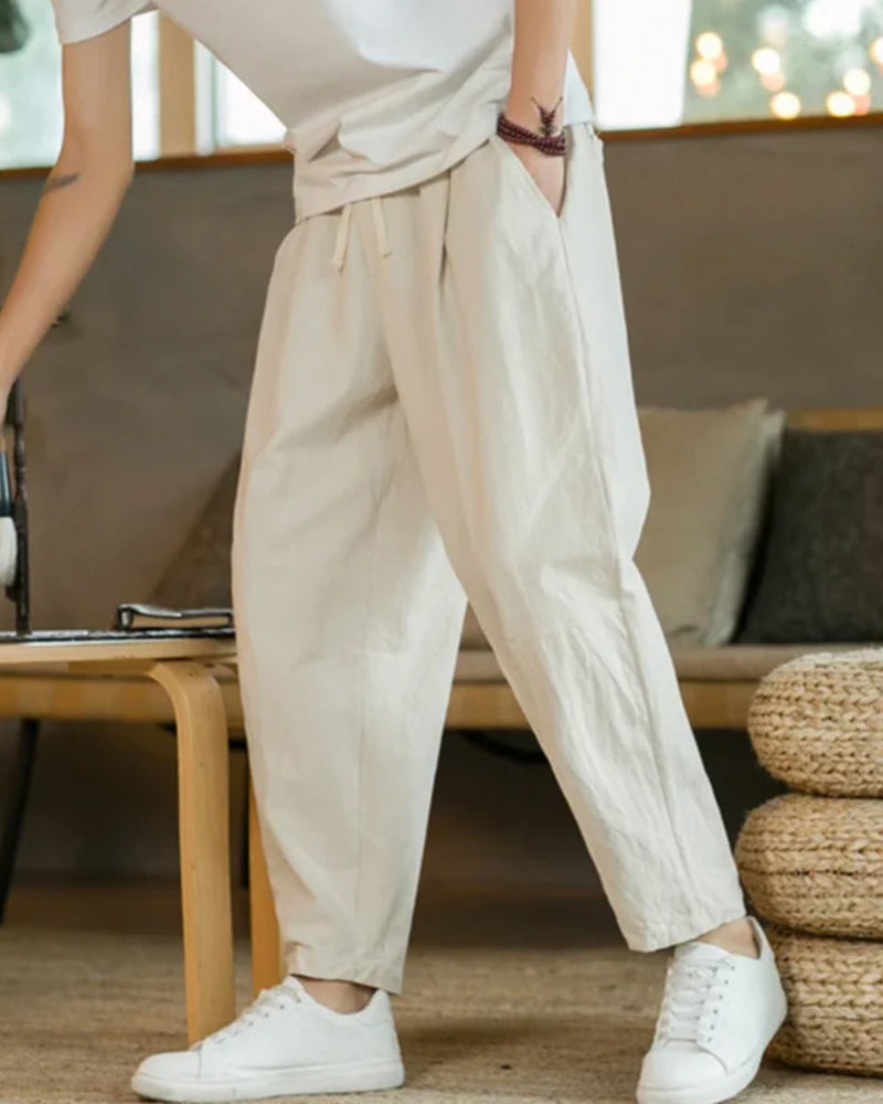 Men's relaxed fit tapered cotton trousers with drawstring waist, perfect for casual comfort & versatile style.