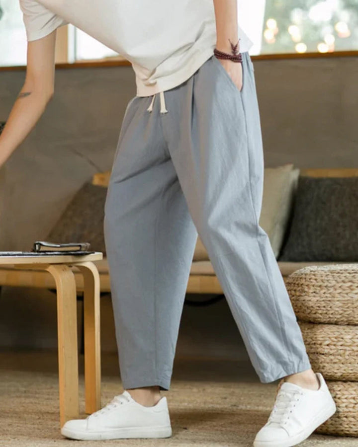 Men's tapered leg cotton trousers, emphasizing modern fit & comfortable versatile style for everyday casual wear.