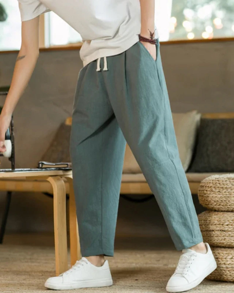 Premium soft cotton fabric men's relaxed fit tapered trousers, highlighting comfort & quality for casual wear.