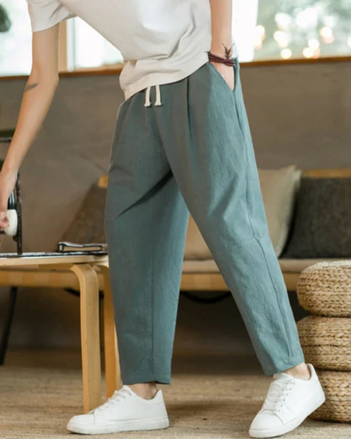 Premium soft cotton fabric men's relaxed fit tapered trousers, highlighting comfort & quality for casual wear.