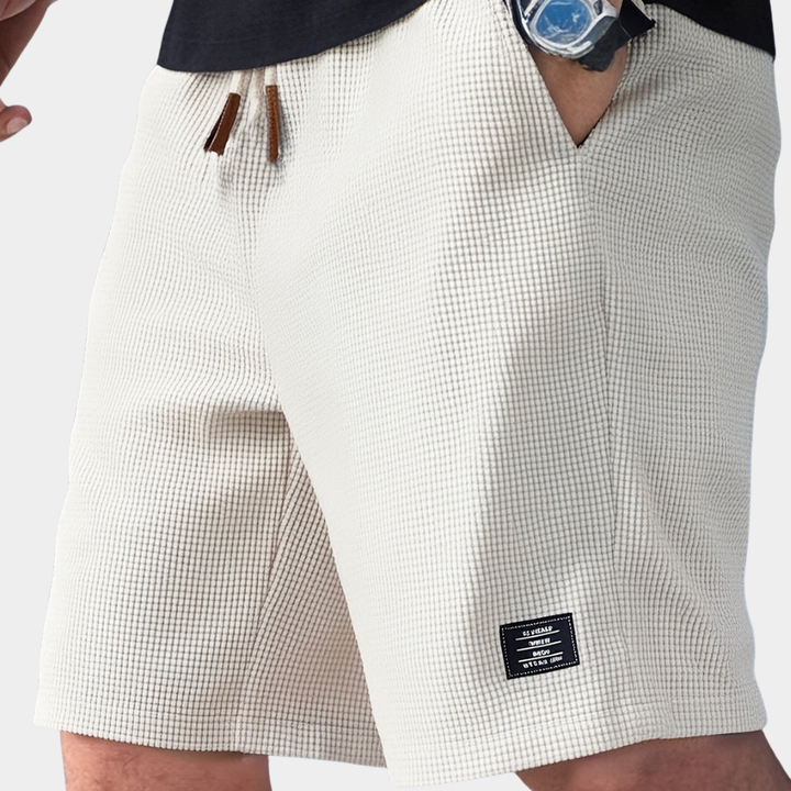 Men's relaxed fit textured waffle knit shorts with drawstring, ideal for casual summer comfort.