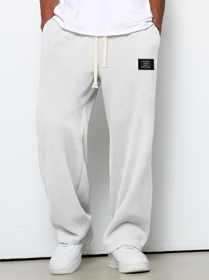 Breathable men's trousers with adjustable waist, perfect for summer comfort.