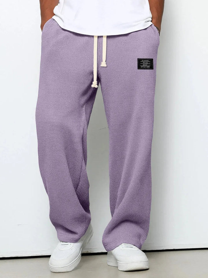 Comfortable men's trousers, relaxed fit with a practical drawstring waist for versatility.