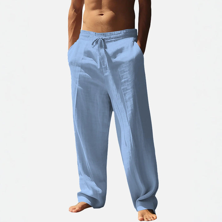 Men's relaxed fit trousers with elastic waist, drawstring, and side pockets for casual comfort.