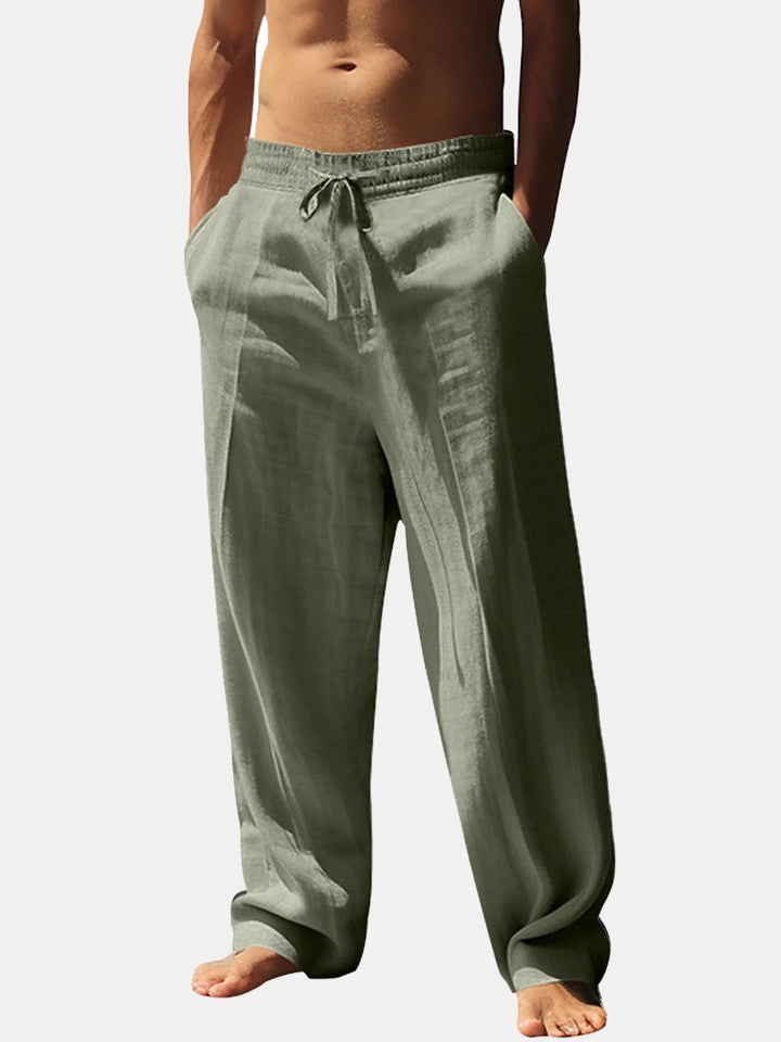 Practical men's relaxed fit summer trousers with elastic waist and pockets, suitable for holidays and everyday wear.