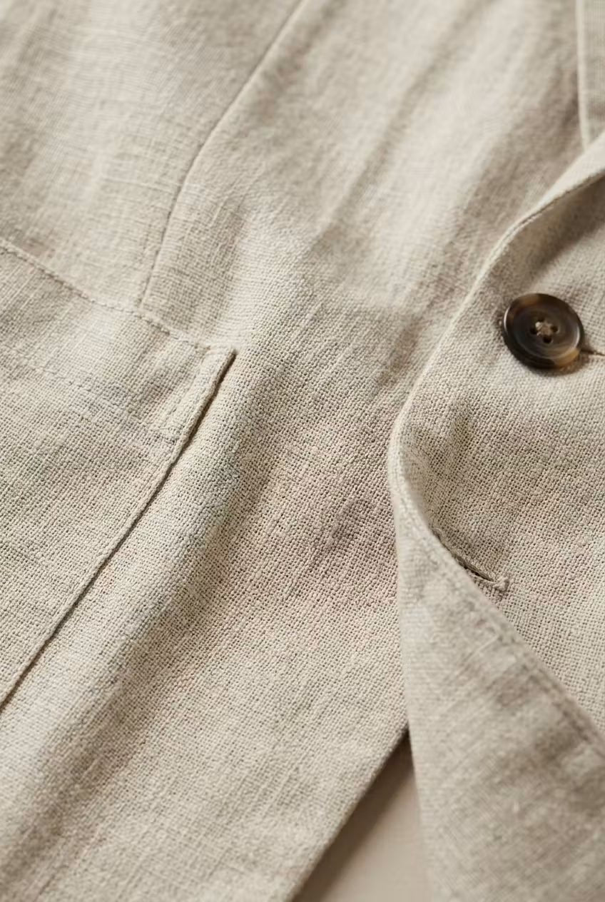 Close-up of the comfortable fabric of a men's relaxed fit two-piece suit, suitable for smart casual events.