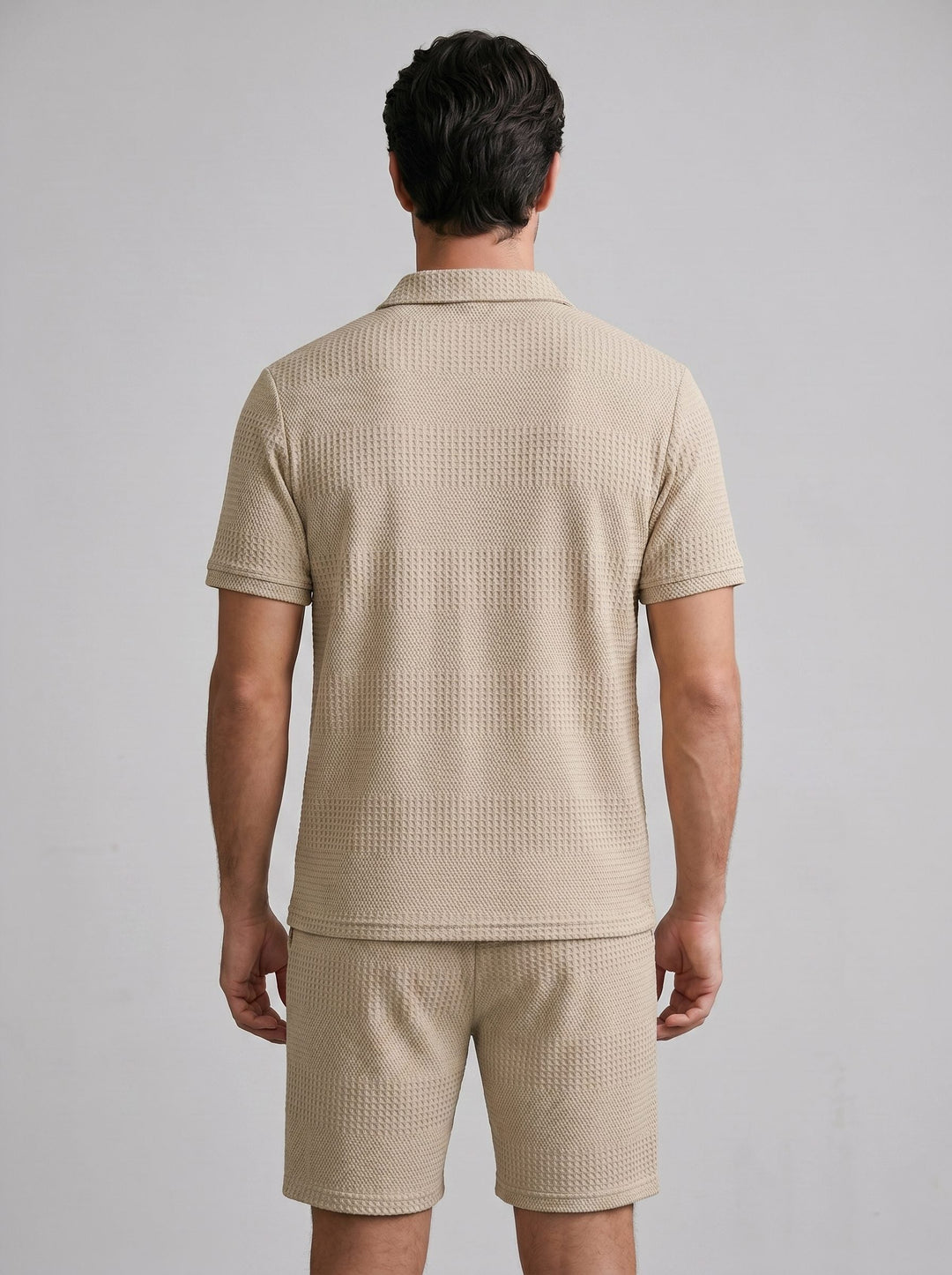 Textured men's knit polo shirt and shorts, a versatile casual summer outfit.