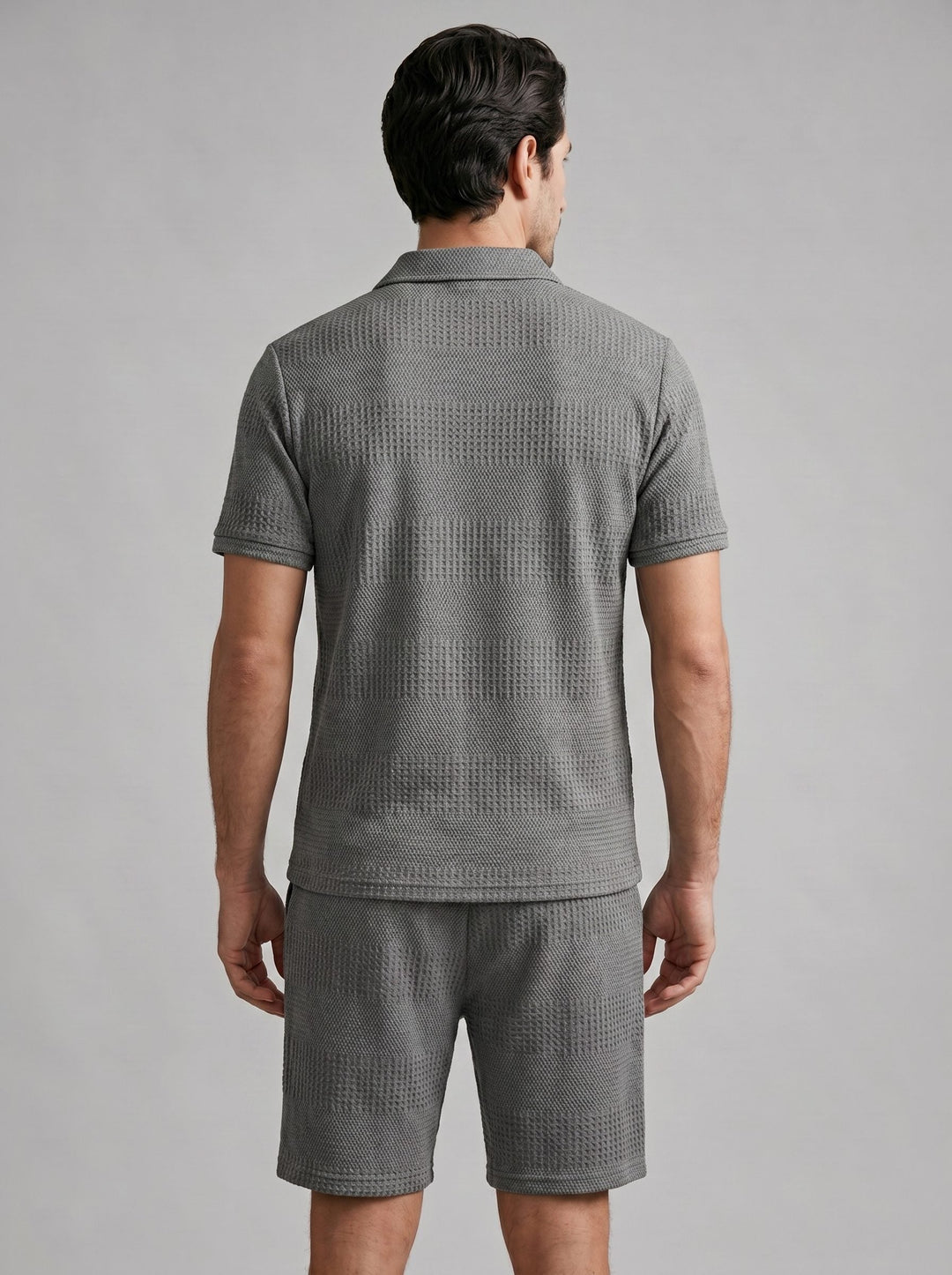 Coordinated men's textured knit polo shirt and shorts for warm weather.