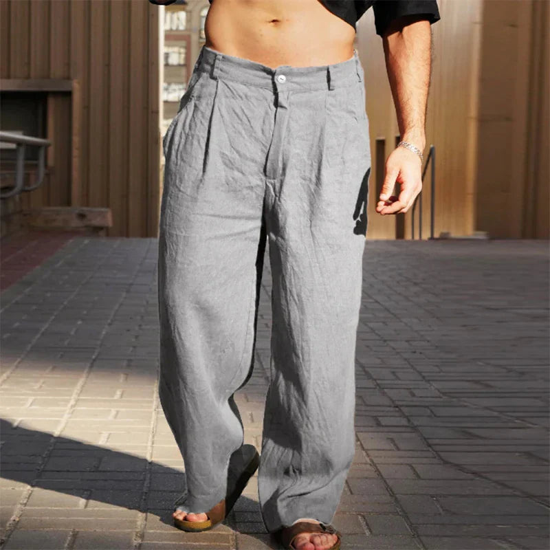 Men's relaxed wide leg linen trousers in beige for summer comfort & style.