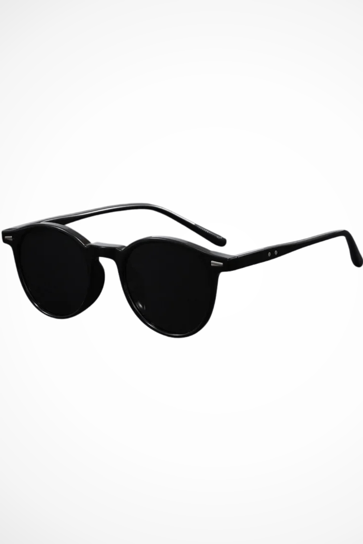Men's retro round sunglasses; dark lenses provide stylish sun protection for versatile casual wear.