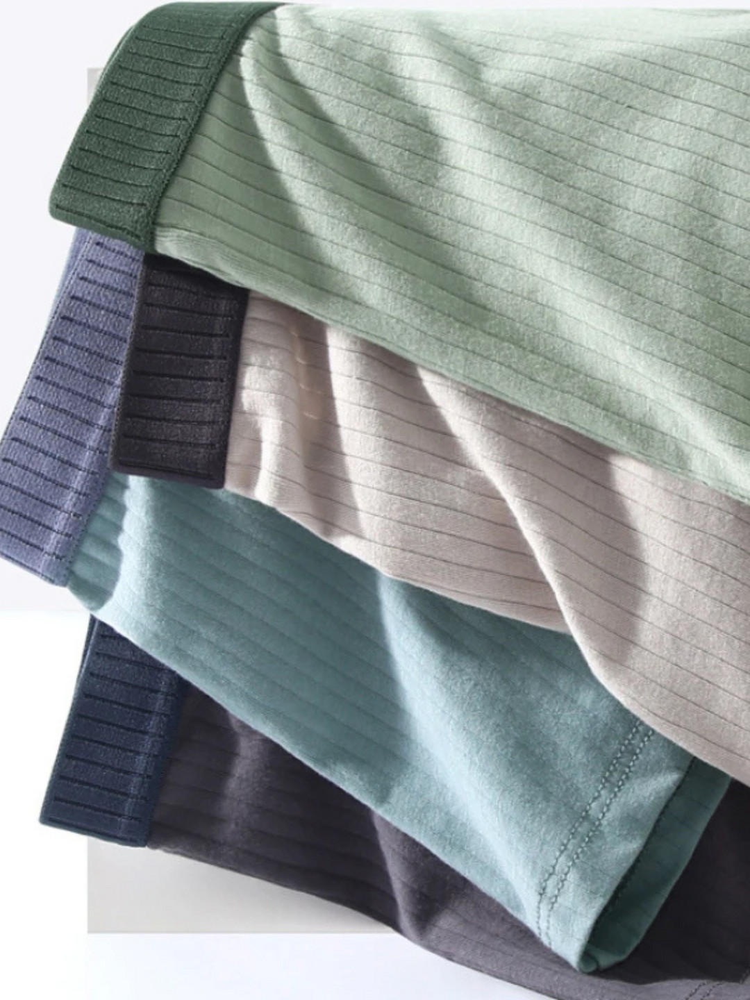 Stack of classic men's ribbed boxer briefs, essential multi-pack for all-day comfort and secure fit.