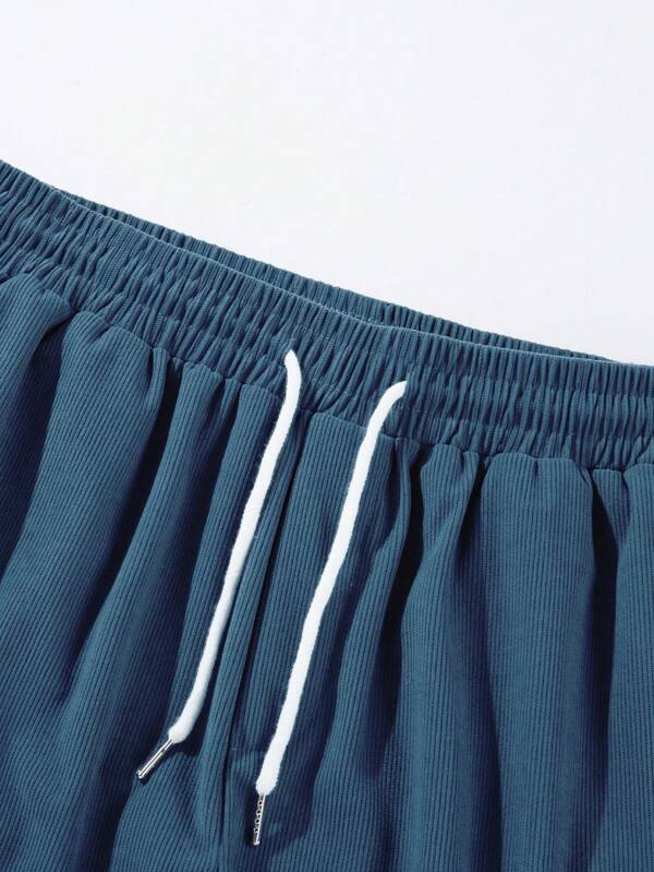 Casual men's mid-thigh shorts with ribbed texture & adjustable drawstring. Great for everyday & summer wear.