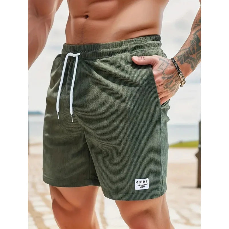 Fashionable men's ribbed swim shorts with drawstring, relaxed fit, essential summer beachwear.