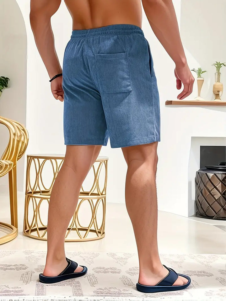 Close-up: Men's ribbed swim shorts texture, showing quick-dry fabric and drawstring detail.