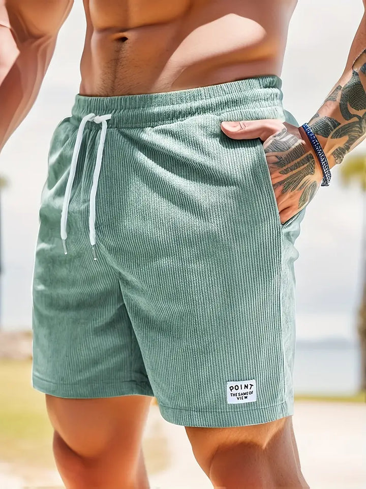 Green men's ribbed swim shorts, elastic waist, quick-dry comfortable beachwear for men.