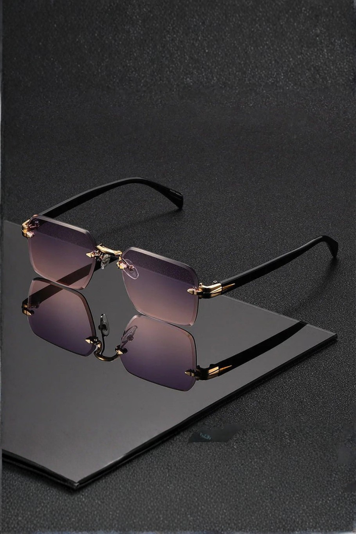 Premium men's rimless eyewear, featuring a striking gold bridge and gradient tinted lenses. Stylish men's accessory.