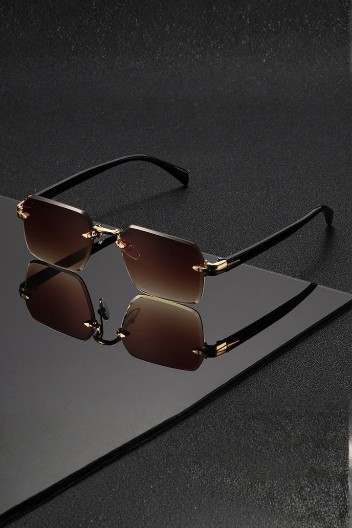 Cool men's rimless sunglasses featuring a stylish gold bridge and trendy gradient tinted lenses. Essential accessory.