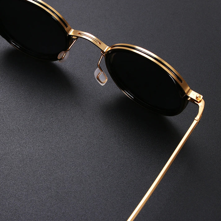 Side profile of men's round polarized sunglasses with sleek vintage metal frame. Classic fashion accessory.