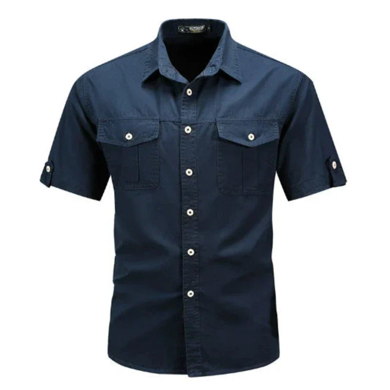 Stylish man wearing a blue short sleeve cargo shirt, a comfortable utility button-up perfect for summer casual fashion.