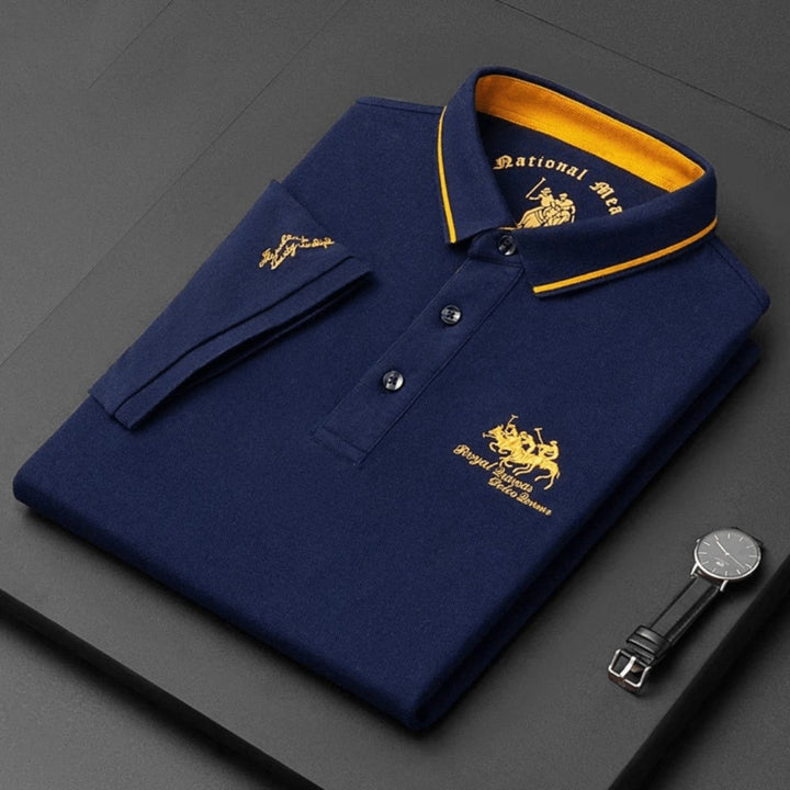 Blue men's short-sleeve polo shirt with stylish tipped collar & subtle embroidery, perfect for golf.