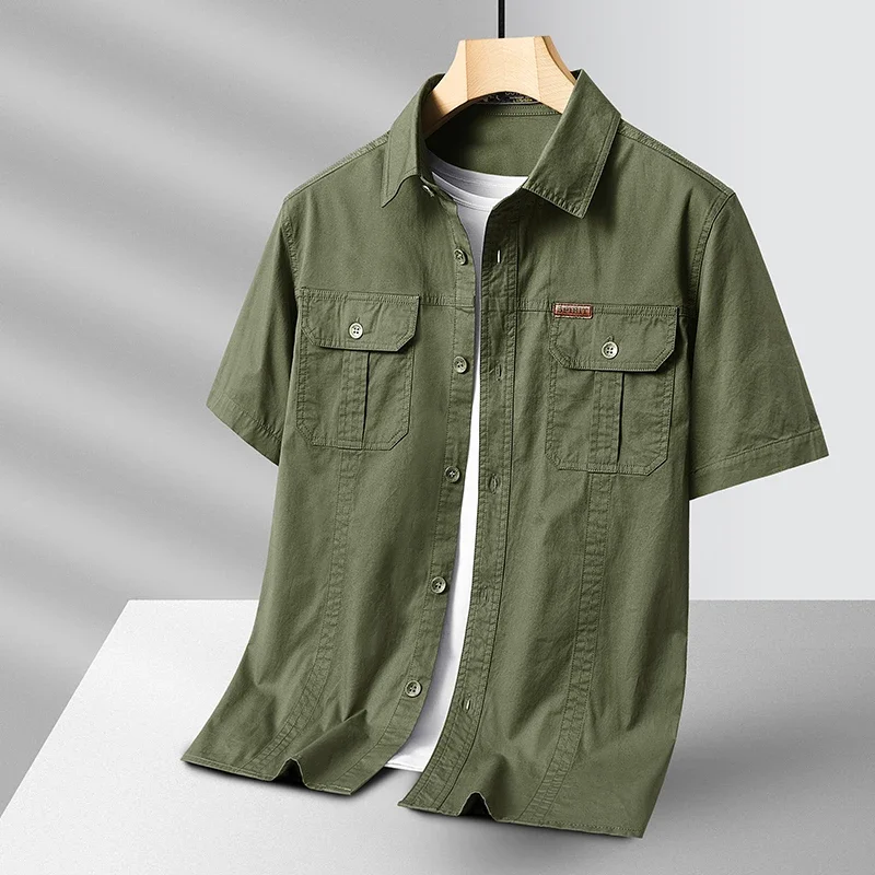 Men's short sleeve utility button-up shirt in light blue, perfect for summer casual wear and travel, with chest pockets.