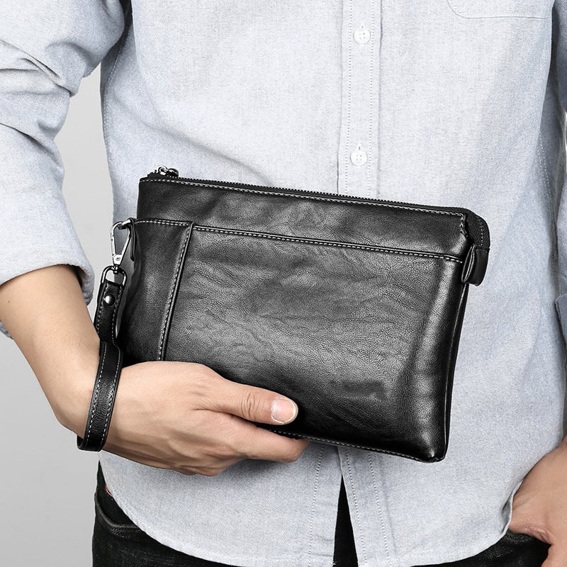 Men's sleek black leather wristlet clutch bag, perfect for everyday carry & travel organizer, sophisticated design.