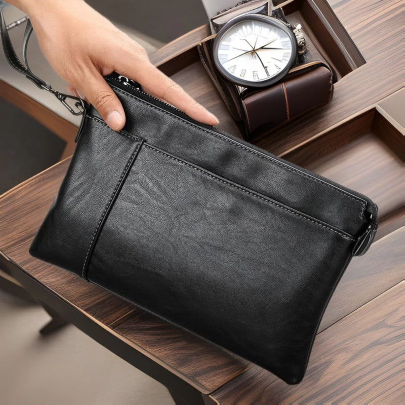 Sophisticated men's black leather clutch bag, a sleek wristlet organizer for everyday essentials & travel.