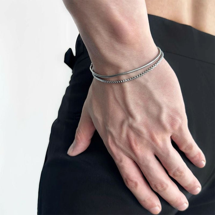 Close-up: Men's adjustable double-chain stainless steel bracelet, sleek silver-tone design, a sophisticated men's jewelry piece.