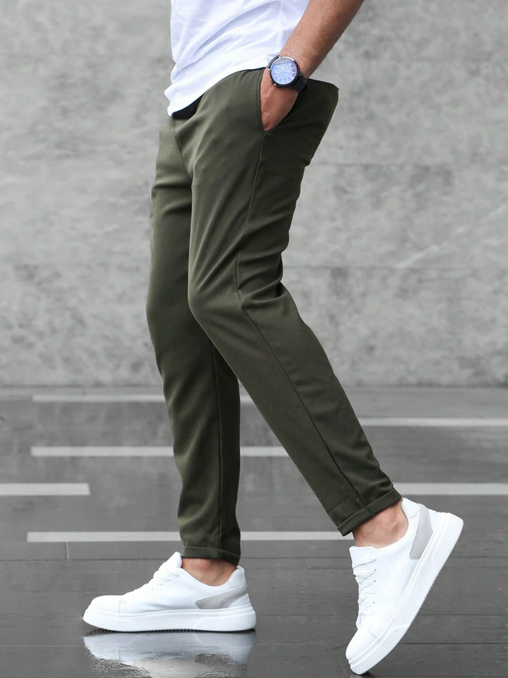 Model wearing versatile men's slim fit drawstring trousers, perfect for smart casual & everyday comfort.