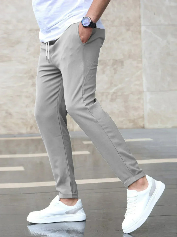 Stylish men's tapered fit trousers with drawstring, ideal for a smart casual look or relaxed comfort.