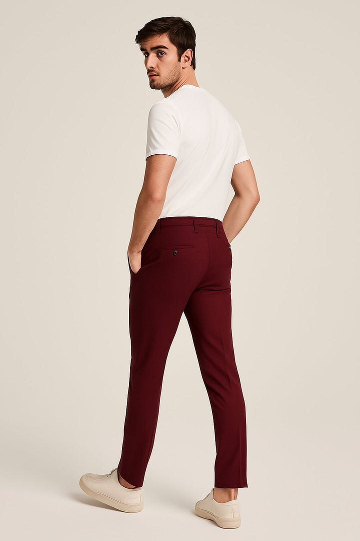 Model in smart casual men's slim-leg khaki chinos. Tailored fit perfect for work or weekend versatility.