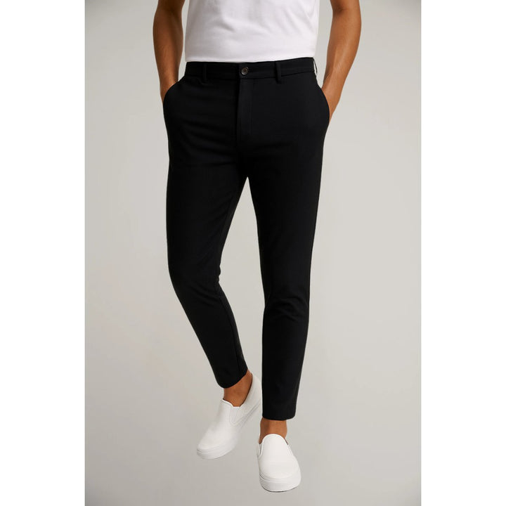 Side profile of men's versatile slim-fit tailored chinos in charcoal. Modern, sleek casual trousers.