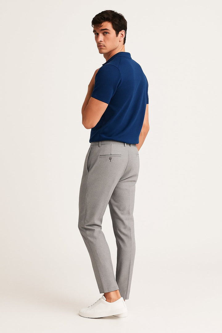 Front detail of men's slim-fit tailored chinos, featuring comfortable woven fabric & a modern leg.