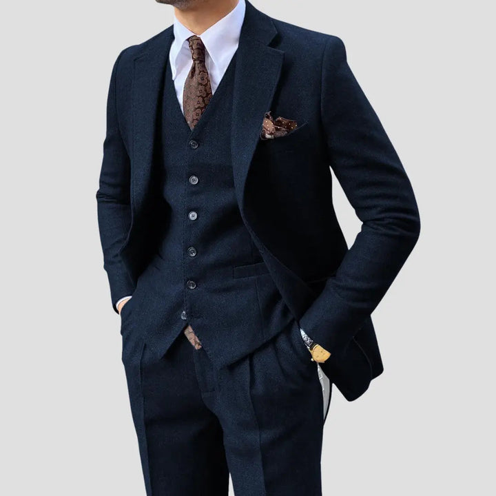 Tailored slim fit three-piece men's suit with matching vest, offering a sharp silhouette.