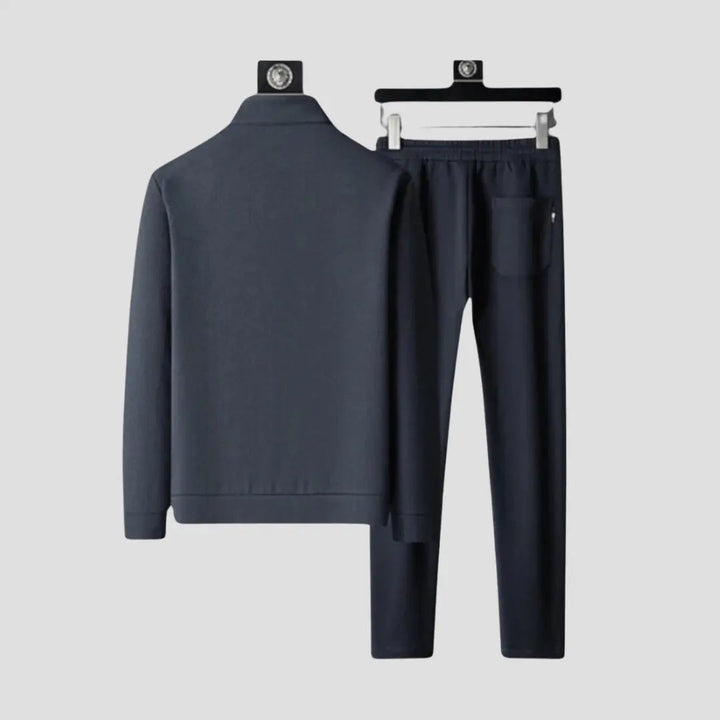 Textured design of men's slim fit tracksuit, highlighting comfortable activewear fabric & modern style.