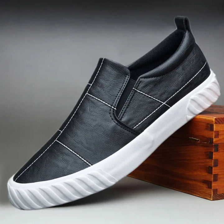 Men's slip-on loafers with modern style, contrast stitching, and comfortable design for everyday wear.