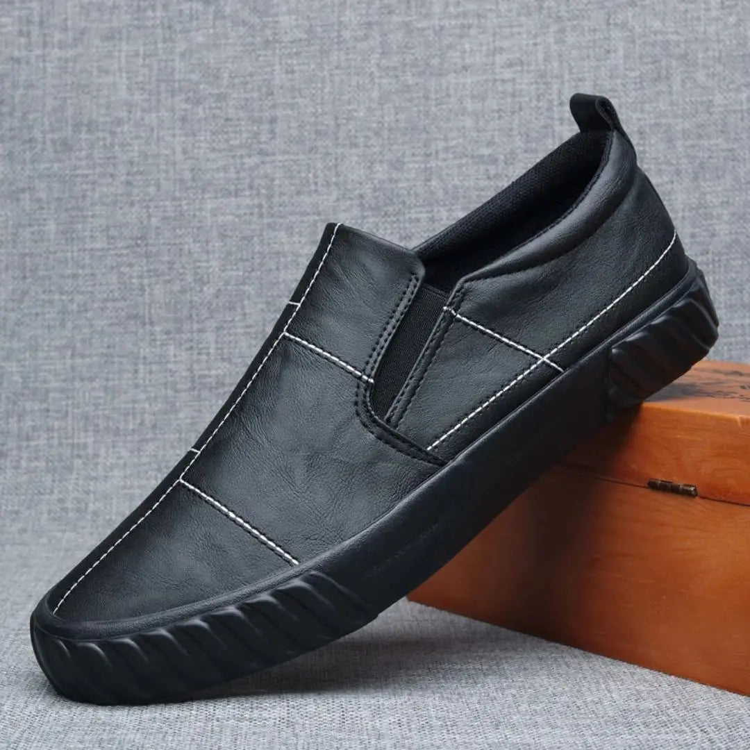 Casual men's slip-on shoes featuring elasticated panels for easy on/off and a comfortable fit.