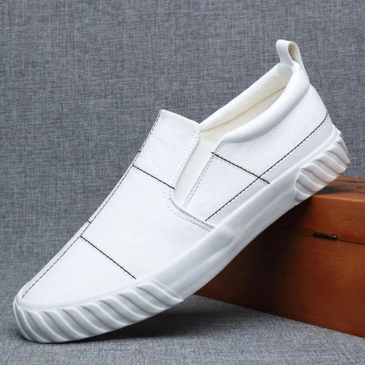 Detailed view of men's slip-on loafers showcasing the stylish contrast stitching. Modern casual footwear.