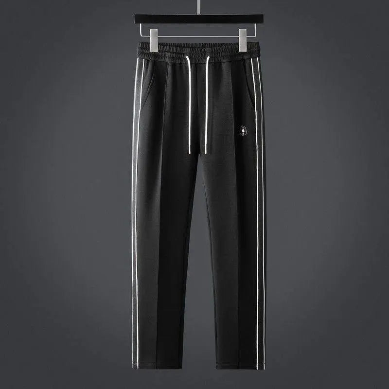 Minimalist men's zip-up tracksuit set with joggers, offering sporty style & everyday comfort.
