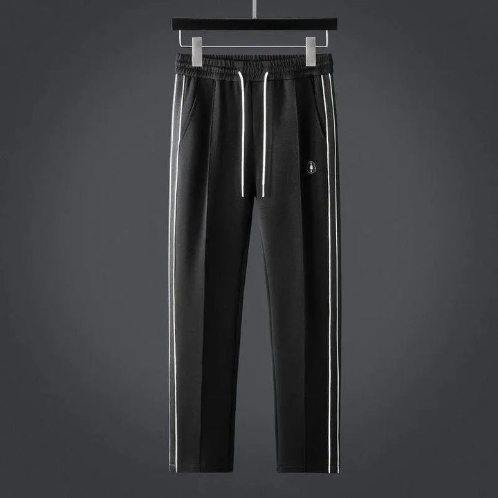 Minimalist men's zip-up tracksuit set with joggers, offering sporty style & everyday comfort.
