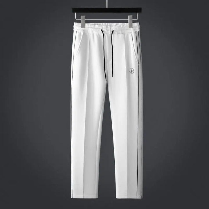 Man wearing a dynamic men's athletic zip-up tracksuit set with joggers, ready for active pursuits.