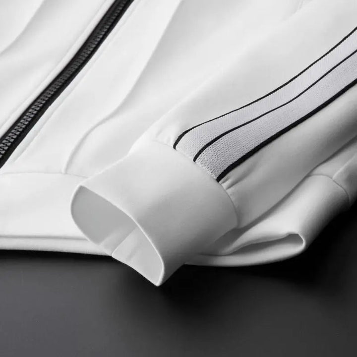 Close-up of comfortable fabric on a men's zip-up tracksuit set with joggers, showcasing quality.