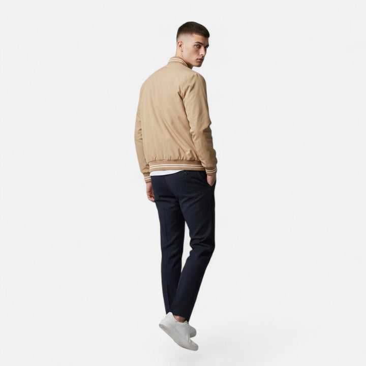 Man wearing a stylish black non-iron stand-collar casual jacket outdoors. Perfect fall outerwear.